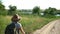 Woman hiking in fields during weekend. Female exploring nature at summer