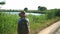 Woman hiking in fields during weekend. Female exploring nature at summer