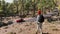 Woman hiking in the forest highly in the mountains on a volcanic rocks