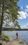 Woman hiking in forest at lake