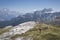 Woman hiking in front of mountain range at Cinque Torri in the Dolomite Alps in summer, South Tyrol Italy