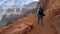 Woman Hiking At The Grand Canyon On A Serpentine Trail With Twists And Turns