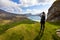 Woman hiking in high mountains near Haukland Beach in beautiful Lofoten, Nordland, Norway