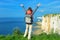 Woman hiking and looking at beautiful sea and rocks view