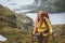 Woman hiking in Norway traveling solo with backpack outdoor active trip healthy lifestyle