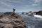 Woman Hiking over Boulder Along California Coast in Point Lobos State Park - Landscape Orientation with Copy Space