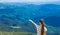 Woman hiking pointing to the sky enjoy the beautiful view at mountain