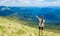 Woman hiking pointing to the sky enjoy the beautiful view at mountain