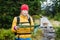 Woman hiking and reading map in forest