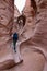 Woman Hiking on Rock Formations in a Utah Slot Canyon