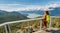 Woman hiking standing at view point Stawamus Chief Hike. Canada Tourism, British Columbia. Hiking tourist in