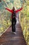 Woman hiking in suspension bridge