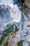 Woman hiking to blue green lake in the Italian Dolomites,Beautiful Lake Sorapis Lago di Sorapis in Dolomites, popular