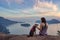 Woman hiking on top of a mountain with a dog