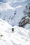 Woman hiking in white winter mountains