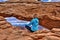 Woman hipster meditating at cliff by Mesa Arch.