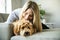 Woman with his Golden Labradoodle dog at home