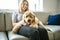 Woman with his Golden Labradoodle dog at home