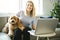 Woman with his Golden Labradoodle dog at home