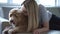 Woman with his golden labradoodle dog at home