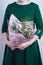 The woman hold bouquet of flowers and kitchen utensils. concept of patriarchal society and gender inequality. Sexism and feminism