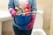 Woman hold bucket with cleaning products in modern bathroom