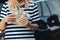 woman hold cash dollar bills next to car with an open tank, concept of rising fuel prices