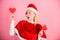 Woman hold heart symbol of love. Bring love to family holiday christmas. I love christmas. Girl happy wear santa costume