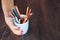 Woman hold mug with many color pencil