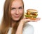 Woman hold tasty unhealthy burger sandwich in hands hungry