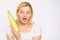 Woman hold yellow corncob on white background. Corn crop harvest concept. Girl hold ripe corn in hand. Food vegetarian