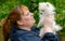 Woman Holding an Adorable White Pomeranian Puppy