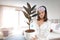 A woman holding an air purifying plants in her hand