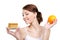 Woman holding appetizing cake and healthy orange