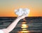 Woman holding Aurora Rainbow Quartz cluster from India in her hand at sunrise