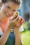 Woman holding a baby chick in her hands very carefully