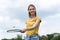 Woman holding badminton racquet with shuttlecock and looking away