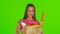 Woman holding bag with groceries food. Green screen. Close up