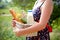 Woman holding a basket with bread, milk and flowers in a summer