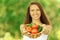 Woman holding basket of tomatoes