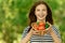 Woman holding basket of tomatoes