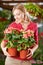 Woman holding begonia flowers in garden center