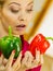 Woman holding bell peppers paprika thinking