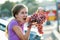 A woman holding big cluster of red juicy grapes in her hand