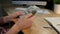 Woman holding bitcoin and wad of cash. Crop view of female hands holding metal bitcoin and bundle of dollar banknotes