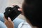 Woman holding black camera in her hands closeup