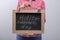 Woman holding blackboard with phrase