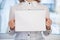 Woman holding blank ring-bound notebook