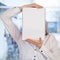 Woman holding blank ring-bound notebook