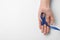 Woman holding blue awareness ribbon on  background, top view. Symbol of social and medical issues